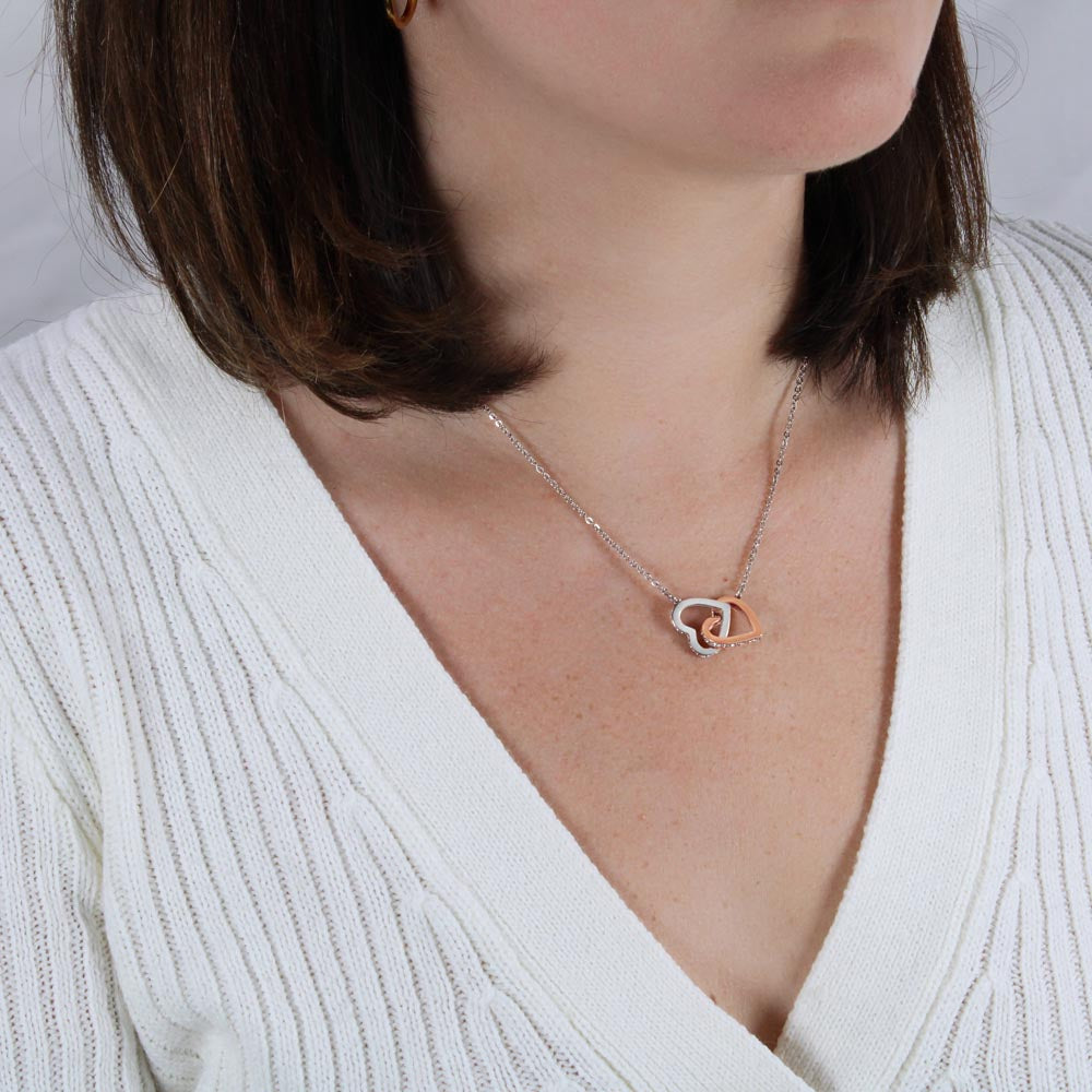 Silver-tone heart pendant necklace worn close-up with layered heart charm.