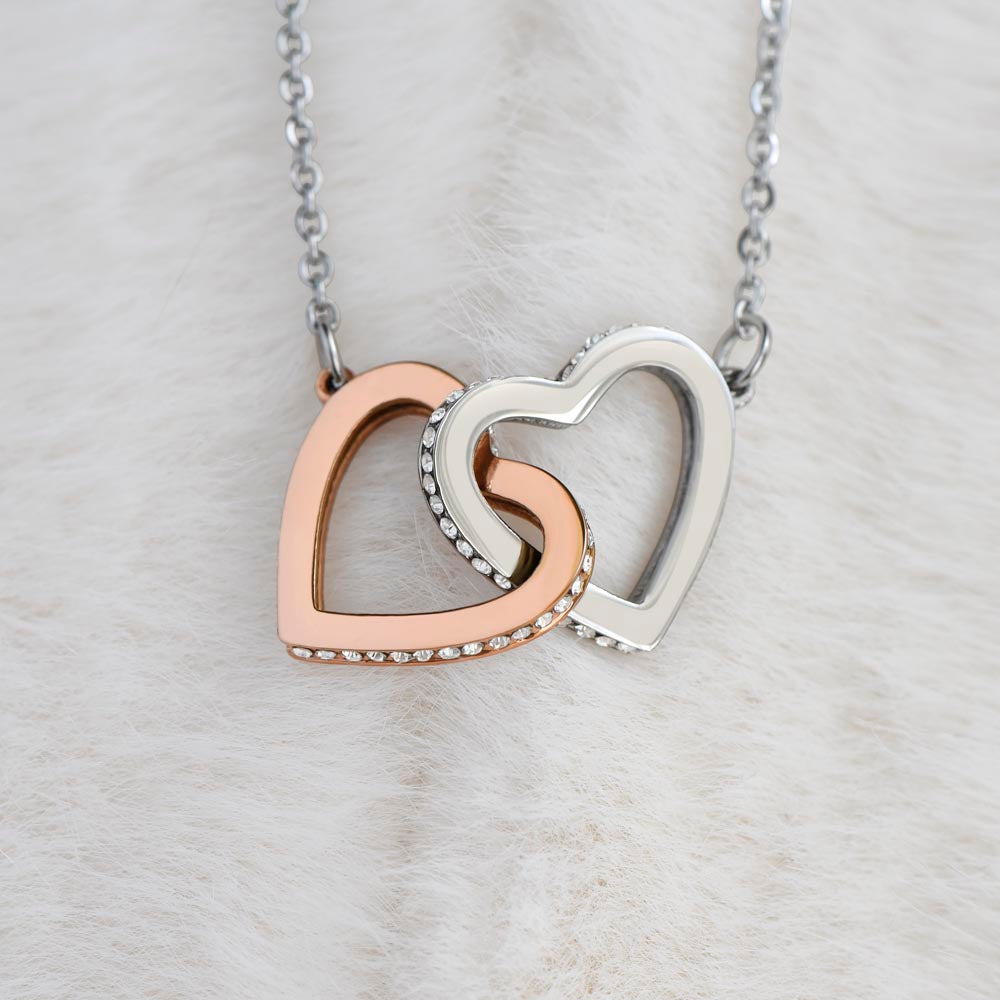 Close-up of interlocking hearts pendant with cubic zirconia stones on silver-tone chain