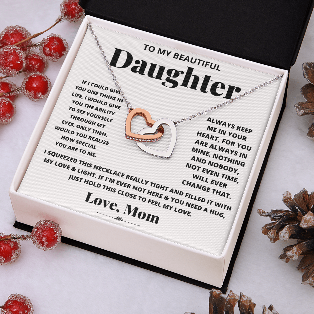 Daughter heart necklace with rose-gold heart pendant on silver-tone chain.