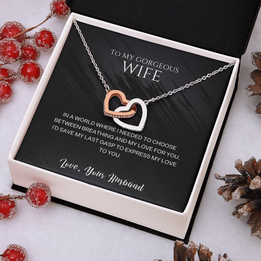 Heart pendant necklace with rose gold and silver-tone layered hearts on a chain.