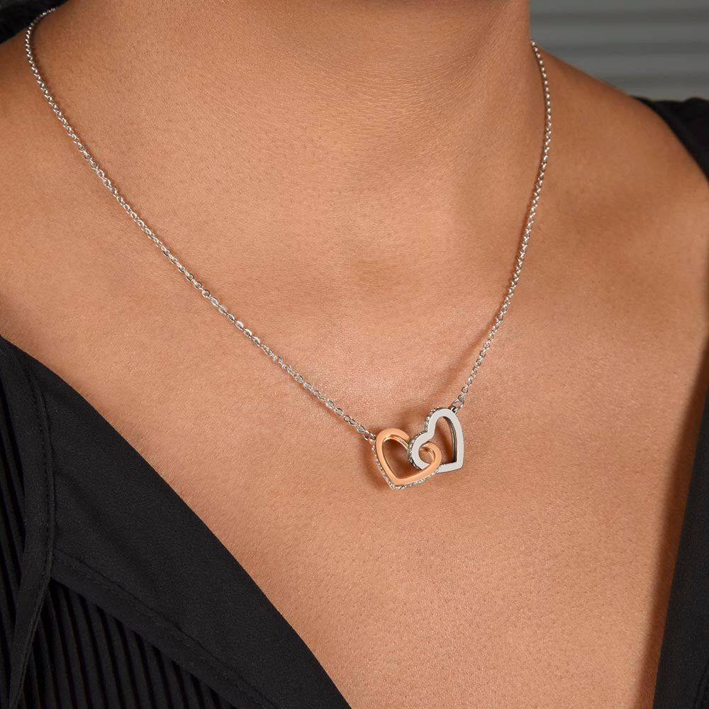 Heart pendant necklace with rose-gold center accent on a thin silver chain