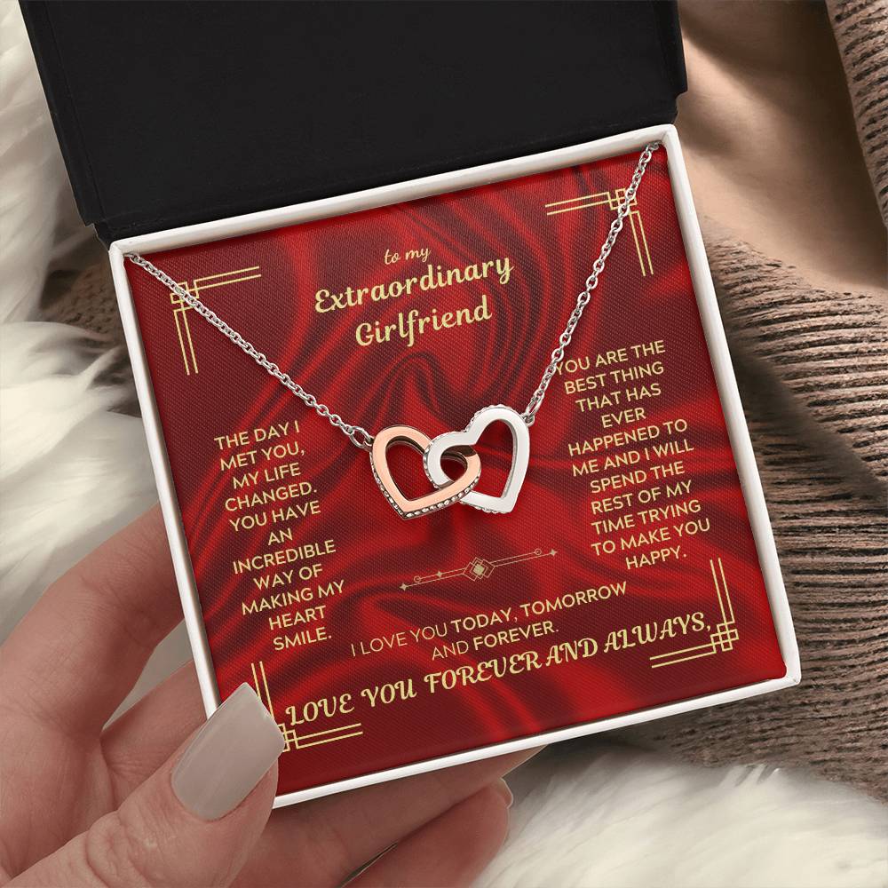 Interlocking heart necklace pendant on chain inside red jewelry box