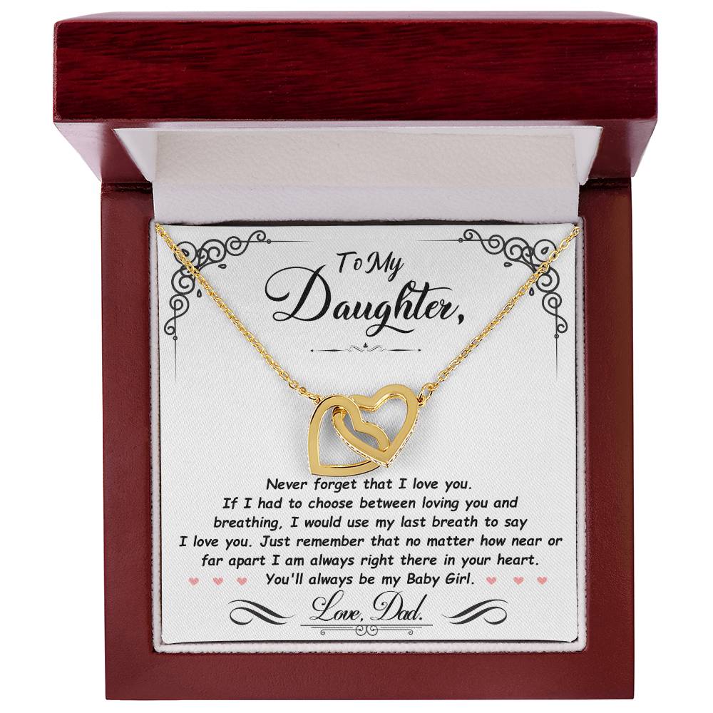 Gold-tone heart pendant necklace with two-tone heart charm in a red gift box