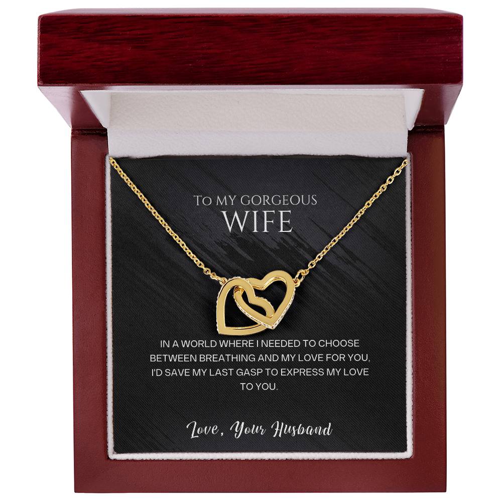 Gold-tone heart pendant necklace in a red gift box with black insert.