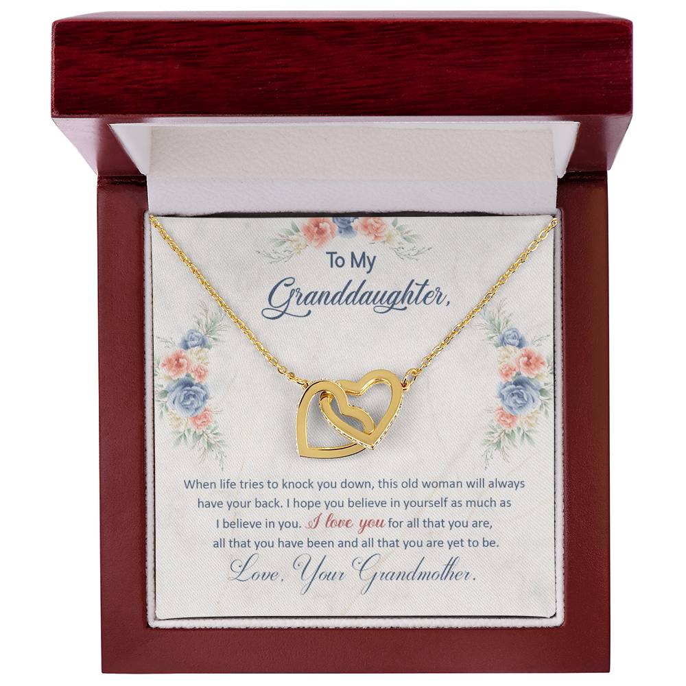 Gold heart pendant necklace shown inside a red floral gift box with note