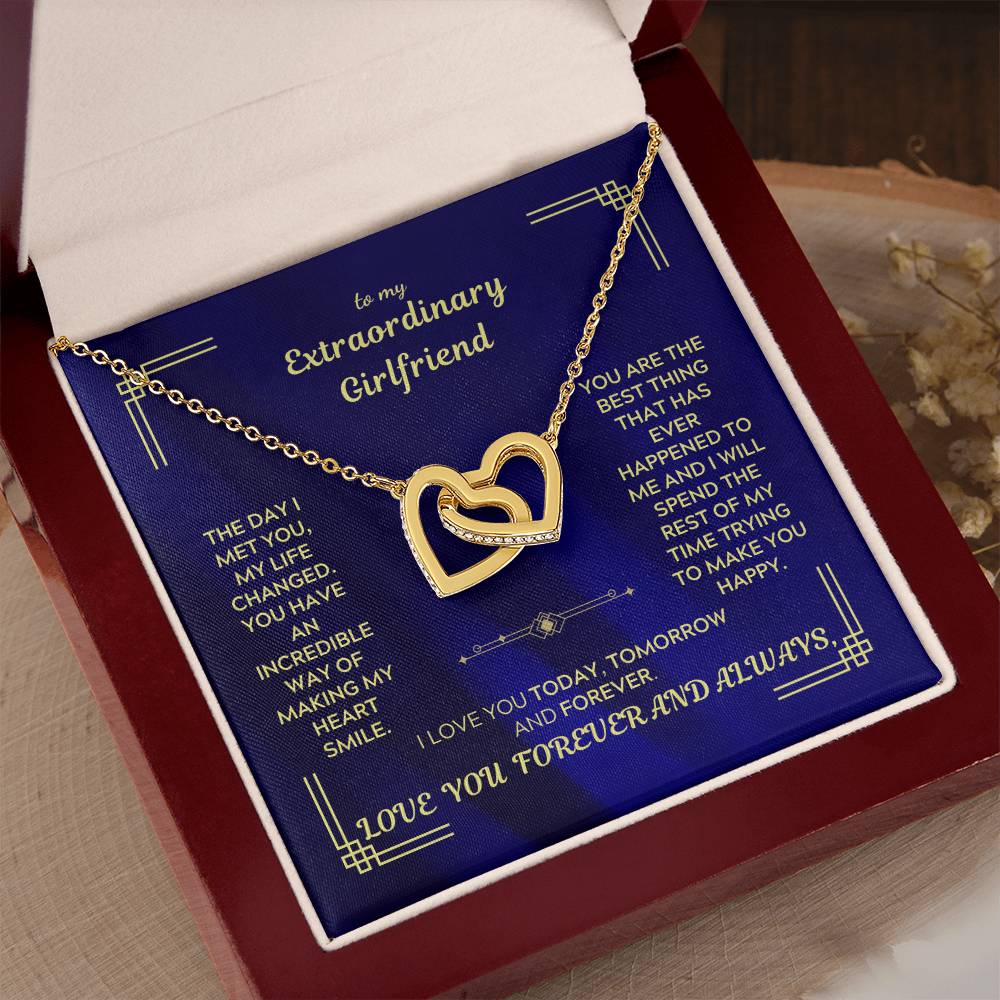 Gold-tone interlocking hearts necklace pendant on chain in blue gift box