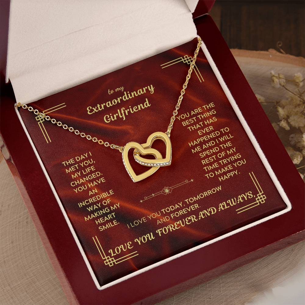 Gold-tone heart pendant necklace shown on red gift box, seated in tray