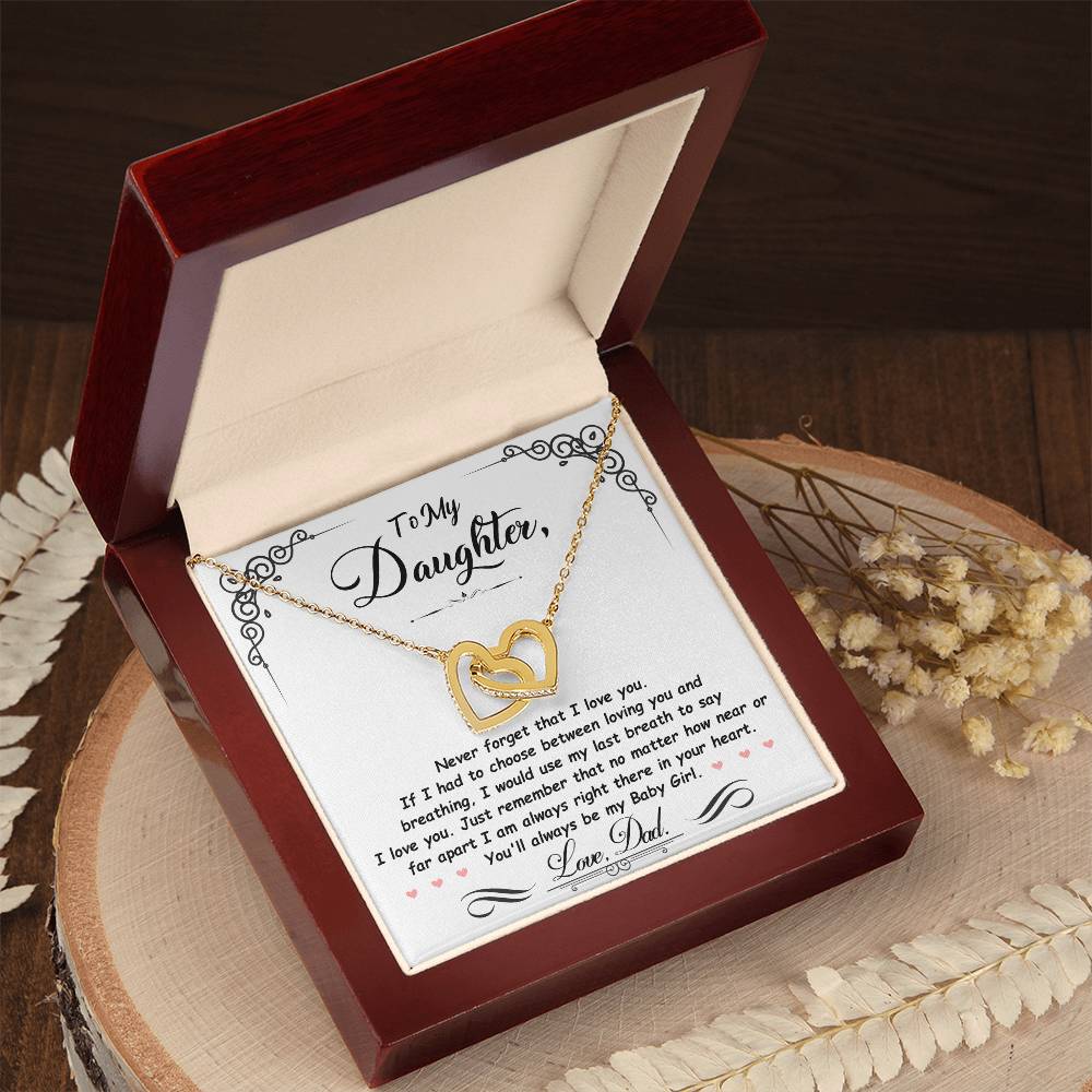 Gold-tone heart pendant necklace with two-tone heart charm in a red gift box