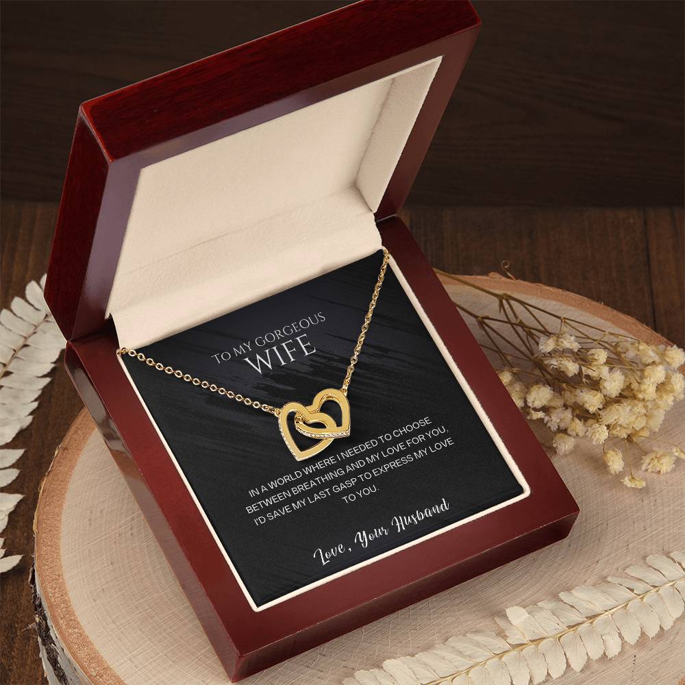 Gold-tone heart pendant necklace shown in an open red gift box on a tray.