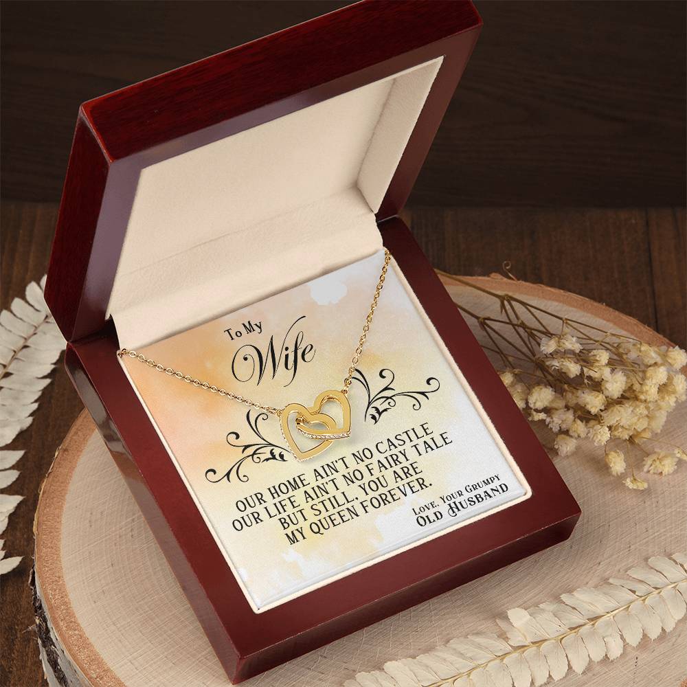 Heart pendant necklace in open red gift box on tray, gold chain and heart pendant