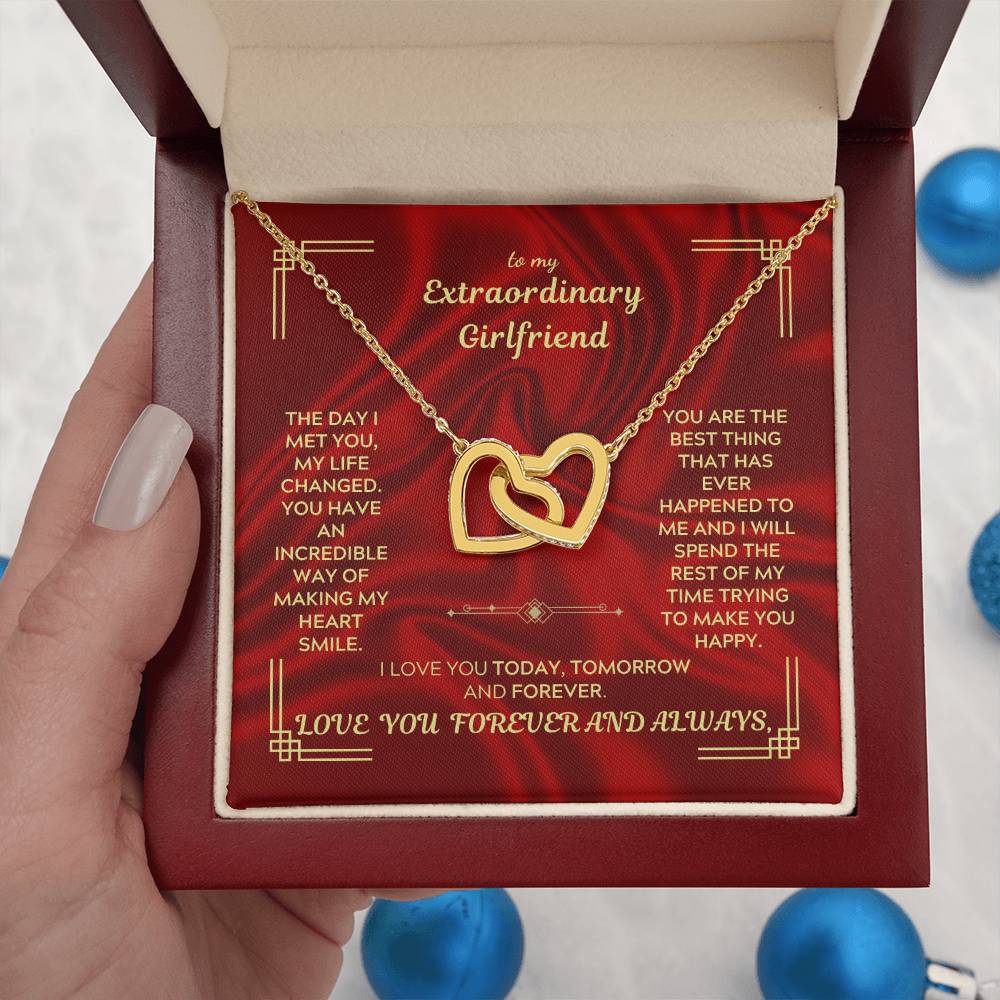 Gold-tone heart pendant necklace with thin chain resting in a red gift box