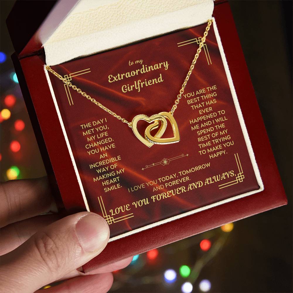 Gold-tone heart pendant necklace resting on red gift box insert, on display