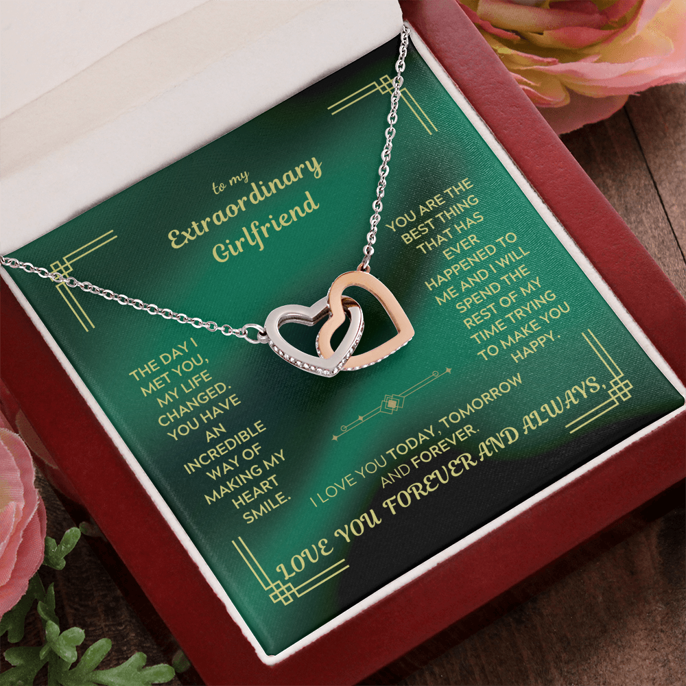 Interlocking heart necklace with silver-tone pendant and rose-gold heart outline in gift box