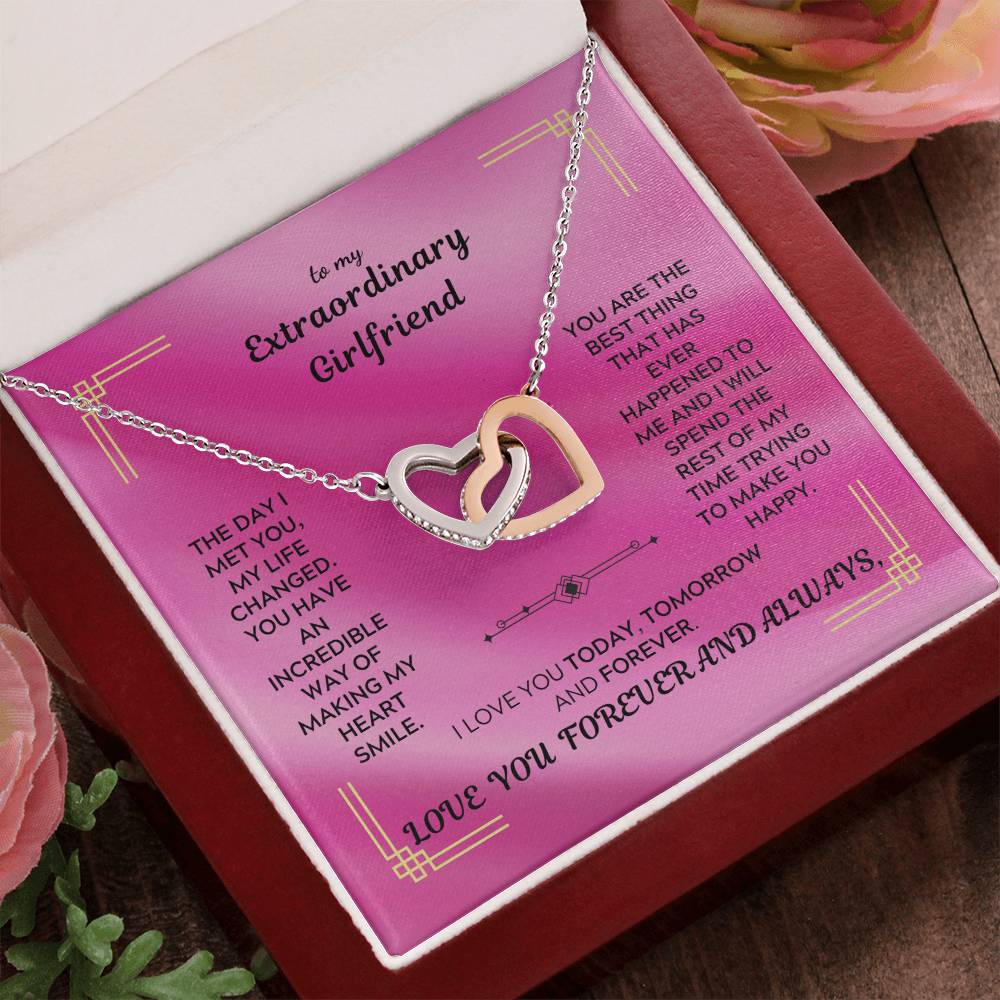 Rose-gold tone interlocking hearts pendant necklace on a pink message card