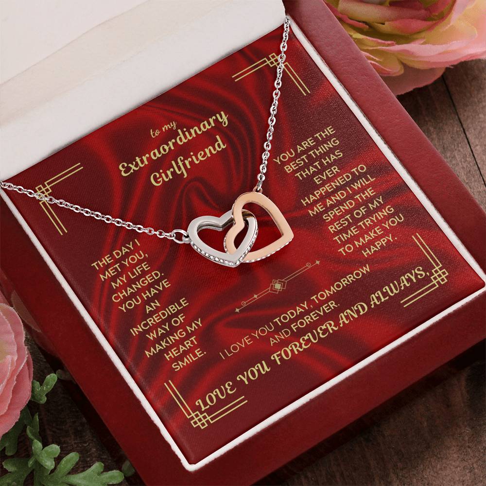 Interlocking heart necklace pendant on chain in red gift box