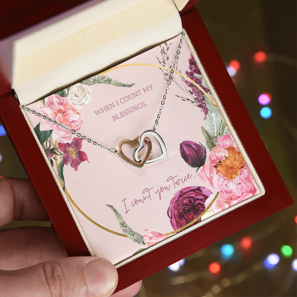 Two-tone heart pendant necklace with linked chain in a jewelry box