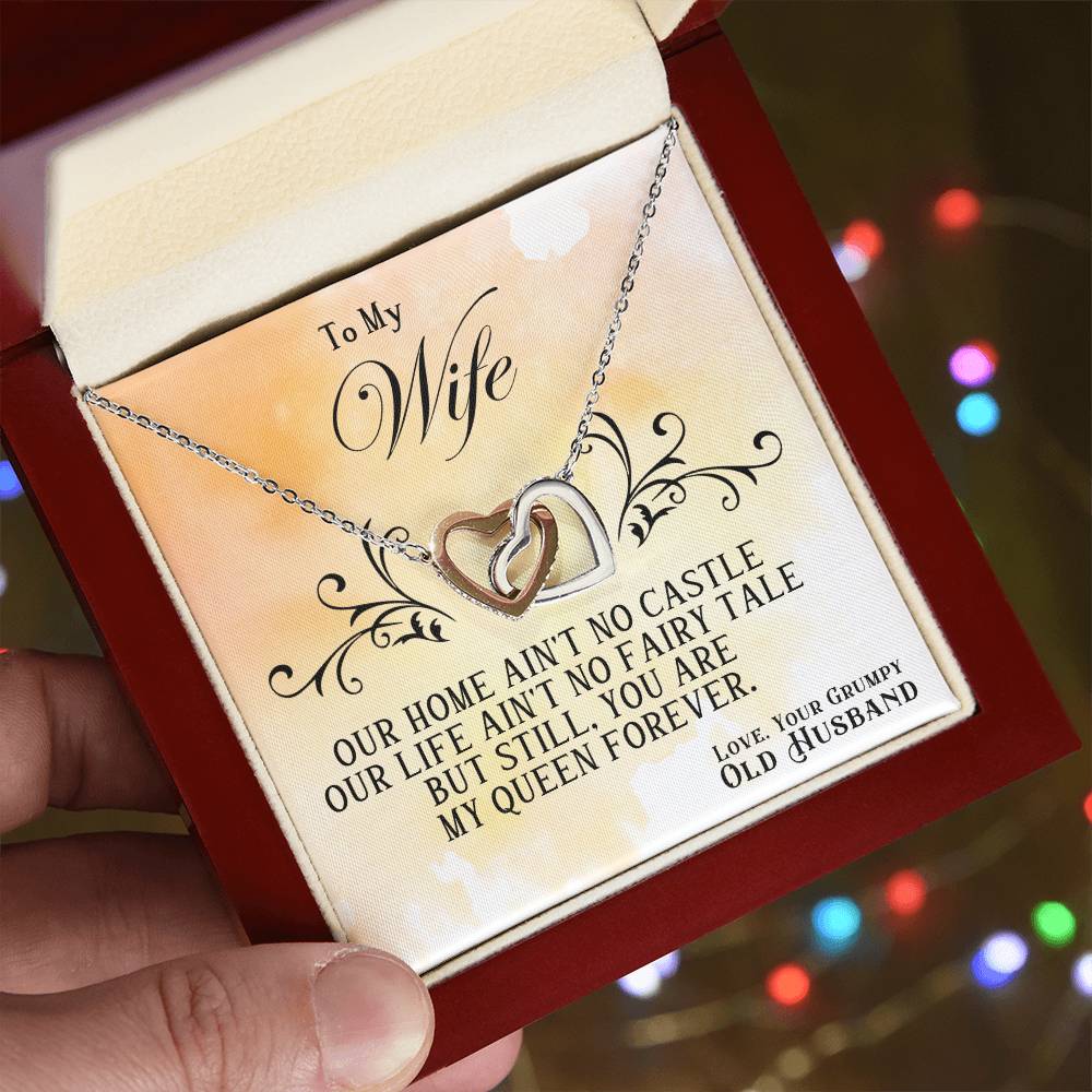 Heart pendant necklace with silver chain in gift box, held close-up