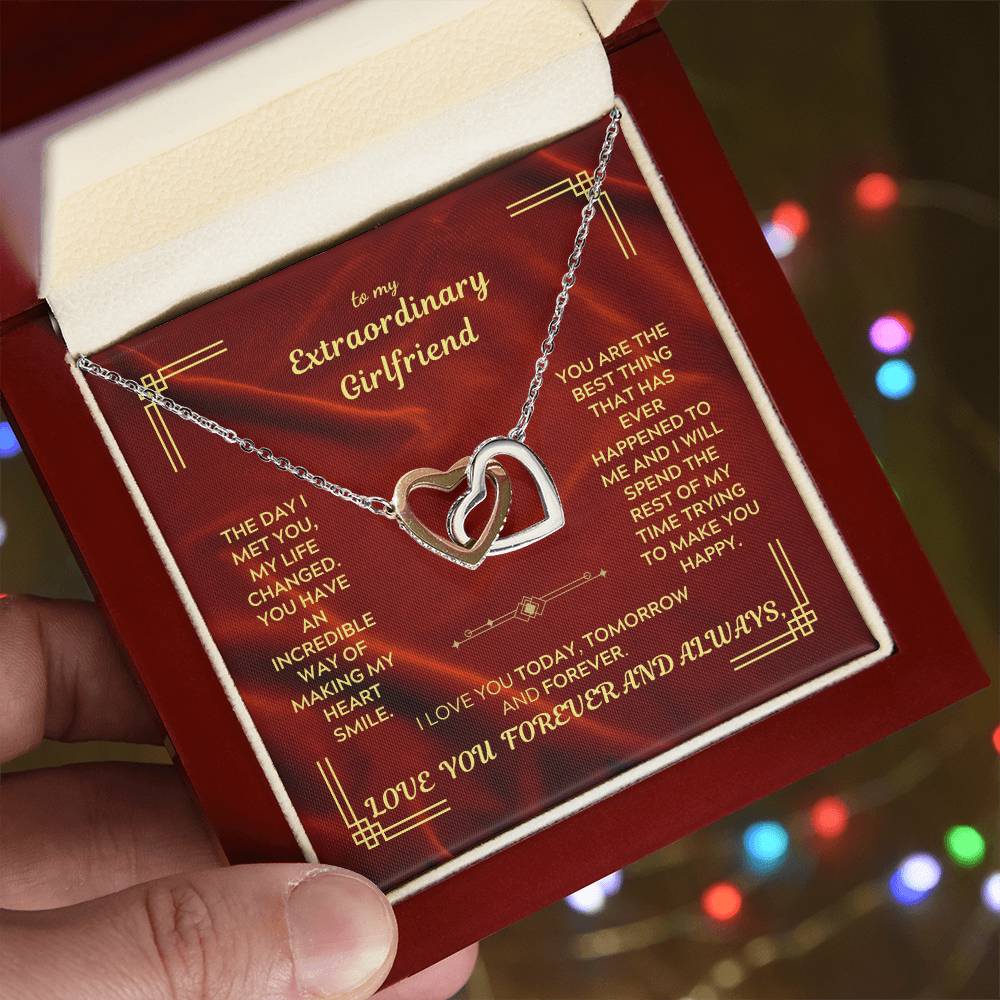 Interlocking hearts pendant necklace on a chain, shown in a gift box