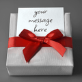 Personalized gift wrap with red ribbon bow and card reading 'your message here'.