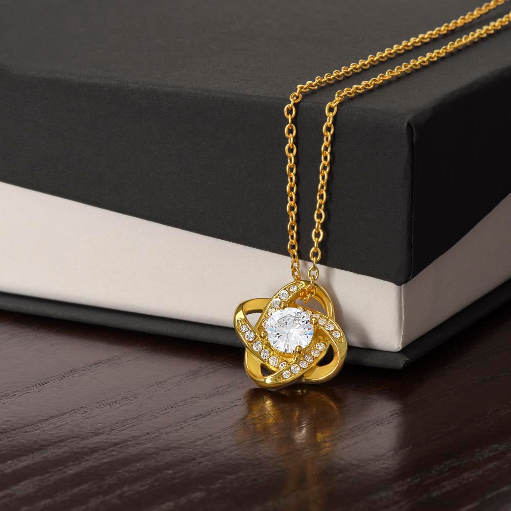 Love knot necklace with gold-tone chain and round crystal heart-knot pendant