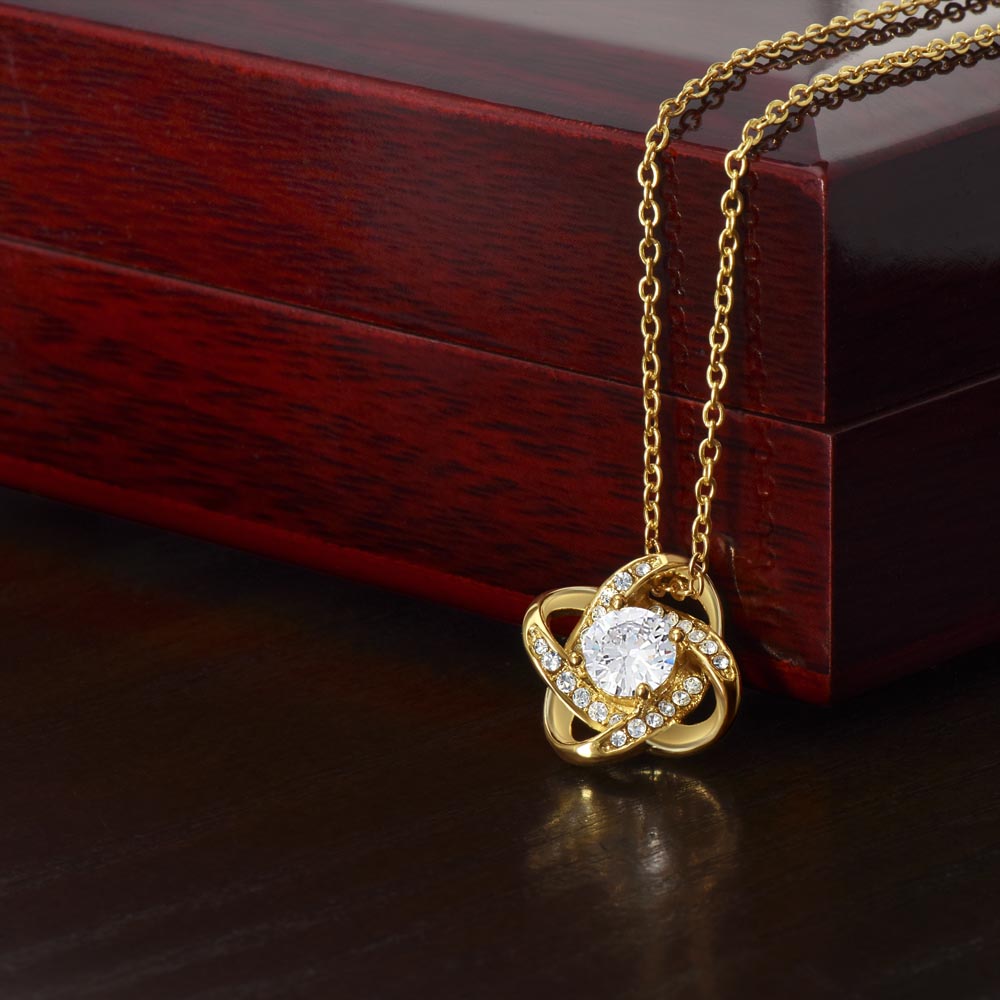 Love knot necklace with gold-tone chain and round crystal pendant