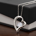 Silver-tone heart pendant necklace with round center stone and sparkling side pave.