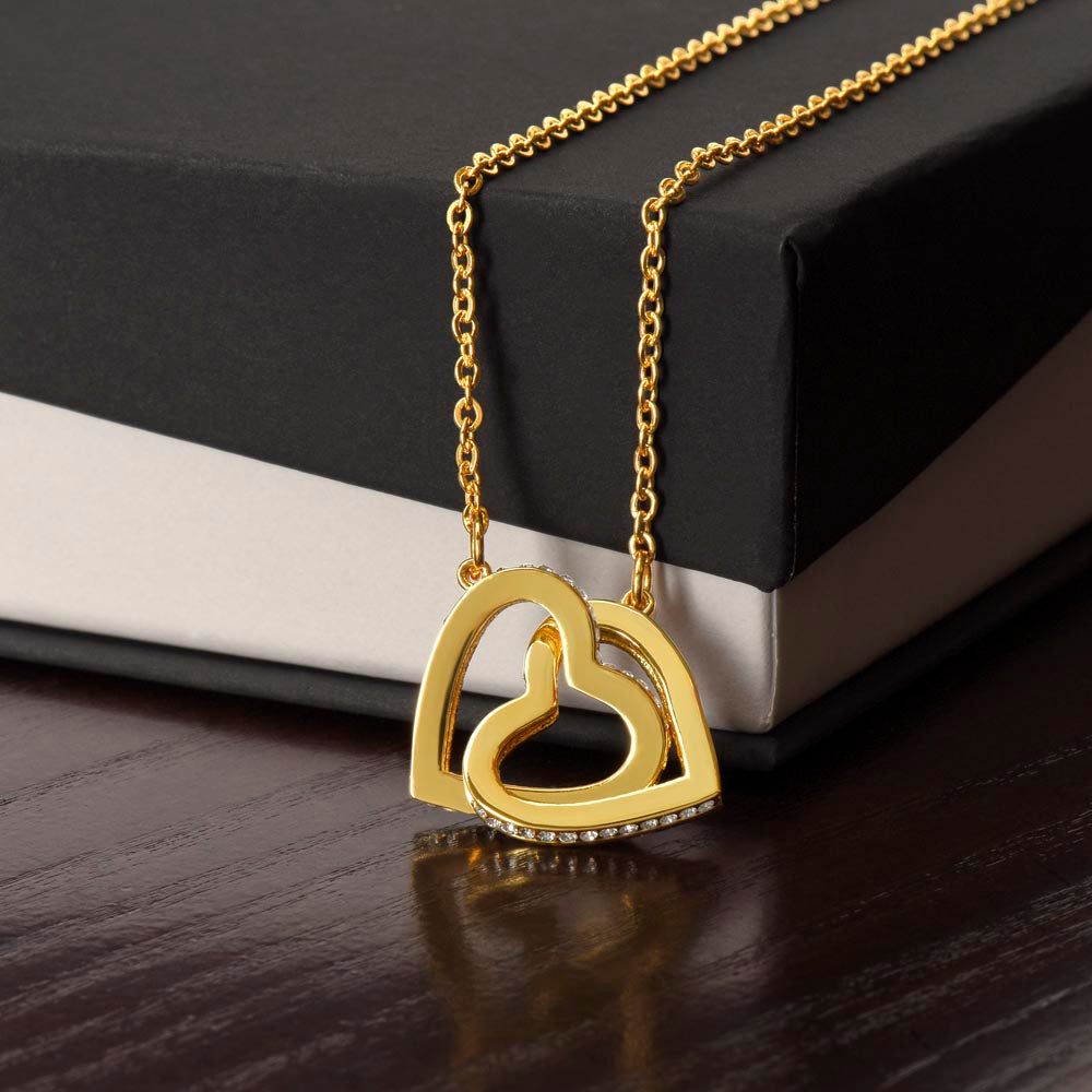 Interlocking hearts necklace with rose-gold and silver heart pendants on gold-tone chain