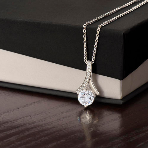 Silver-tone necklace with teardrop pendant and round sparkling stone, slim chain