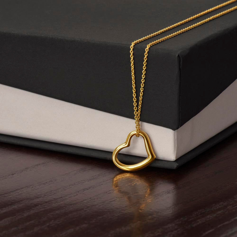 Heart pendant necklace with gold-tone chain and looped heart charm