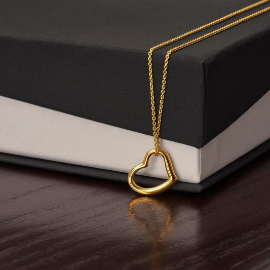 Heart pendant necklace with gold-tone chain and looped heart charm