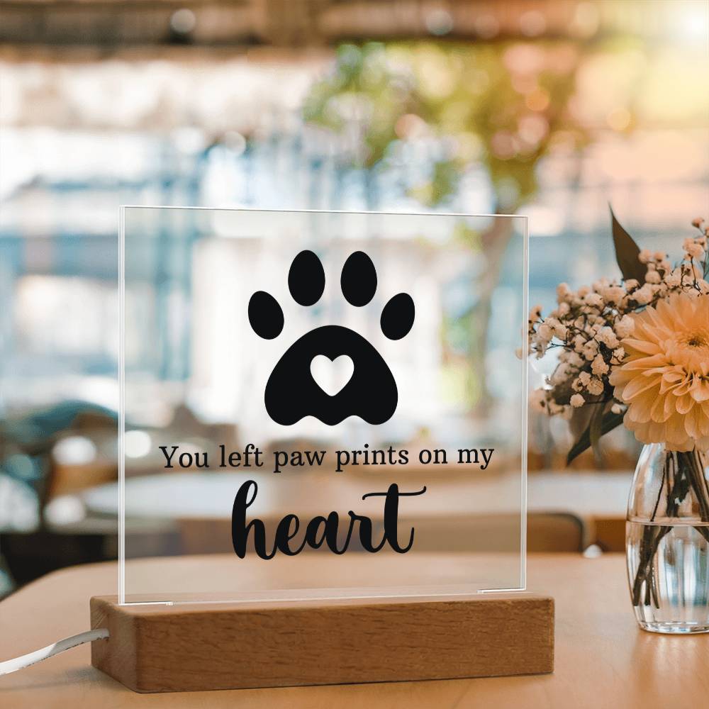 Acrylic keepsake with paw-print heart design and wooden base, bright ambient