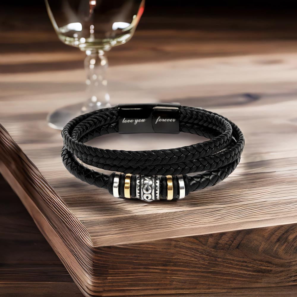 Black braided vegan leather bracelet with decorative beads and magnetic clasp on wood