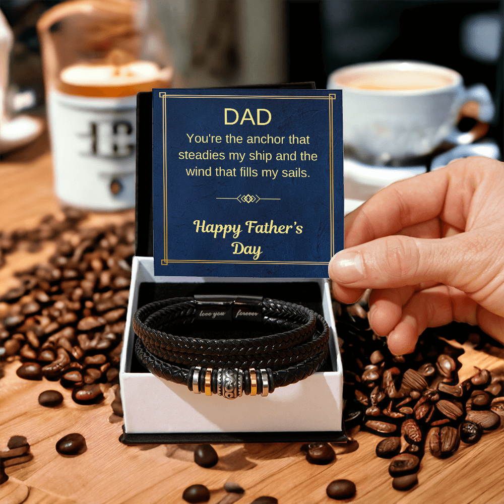 Black braided bracelet in a gift box with a Father’s Day greeting card near coffee beans.