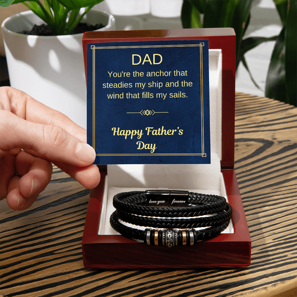Black braided bracelet with gold and silver bead accents in a gift box.