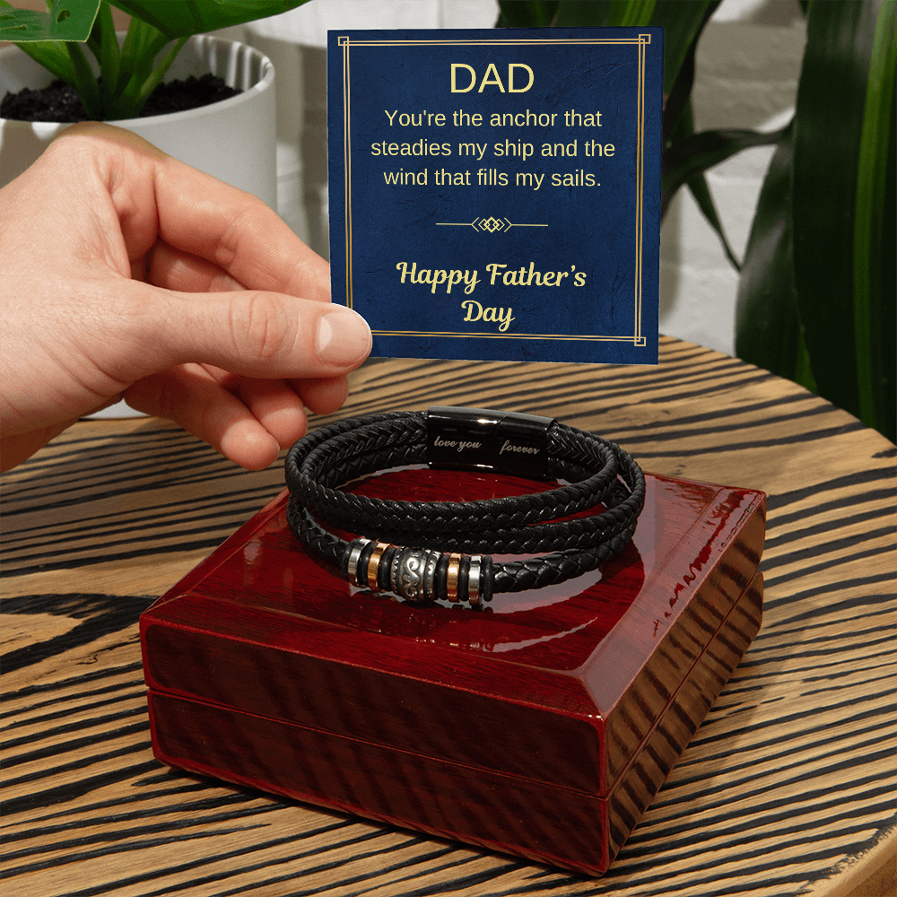 Black braided bracelet on a red gift box with a Father’s Day greeting card.