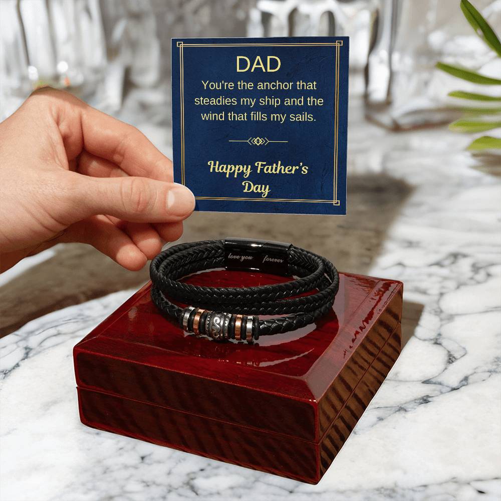 Braided black bracelet with metal bead accents on red presentation box