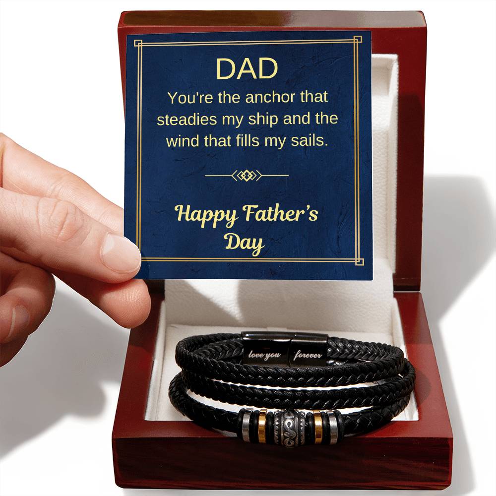 Braided black bracelet with metal bead accents in open red gift box, close view