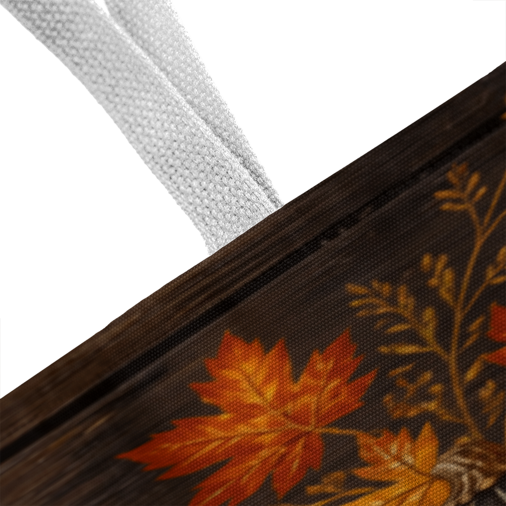 White-handled dark canvas tote bag with orange pumpkin and autumn leaf print