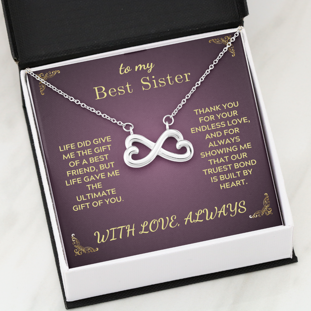 Infinity heart pendant necklace on purple gift card in open box, silver-tone chain