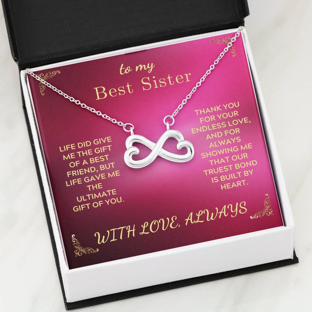 Infinity-heart necklace in purple gift box with open top