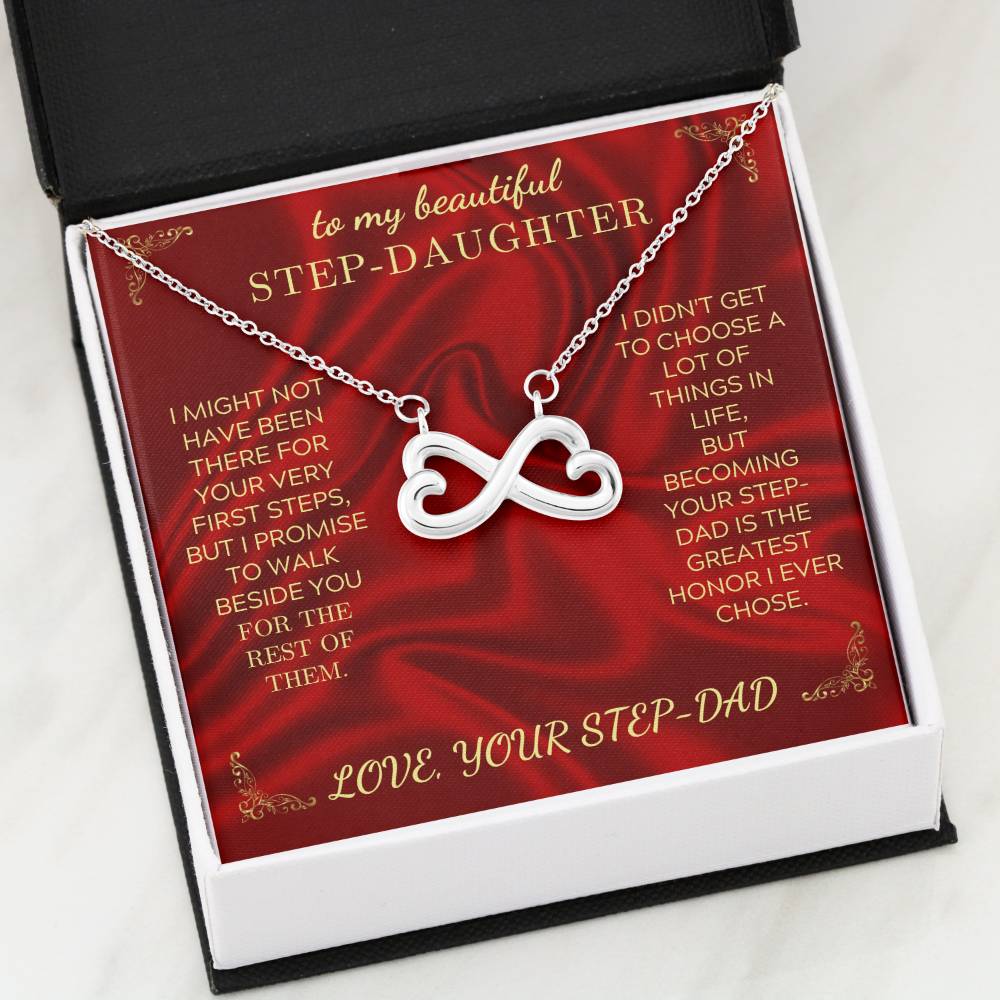 Open gift box with silver heart-infinity pendant necklace on red message card