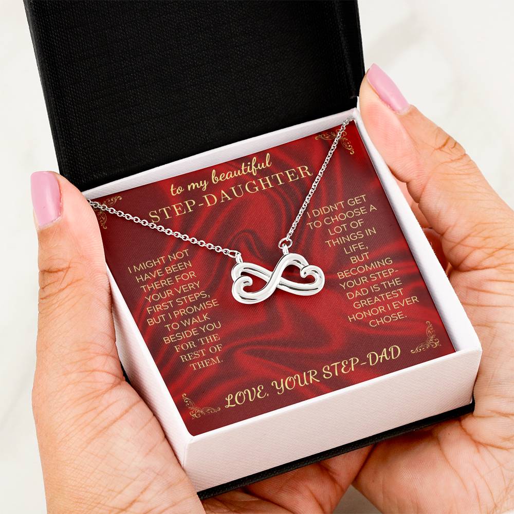 Hand holding open necklace gift box with heart-infinity pendant necklace and card