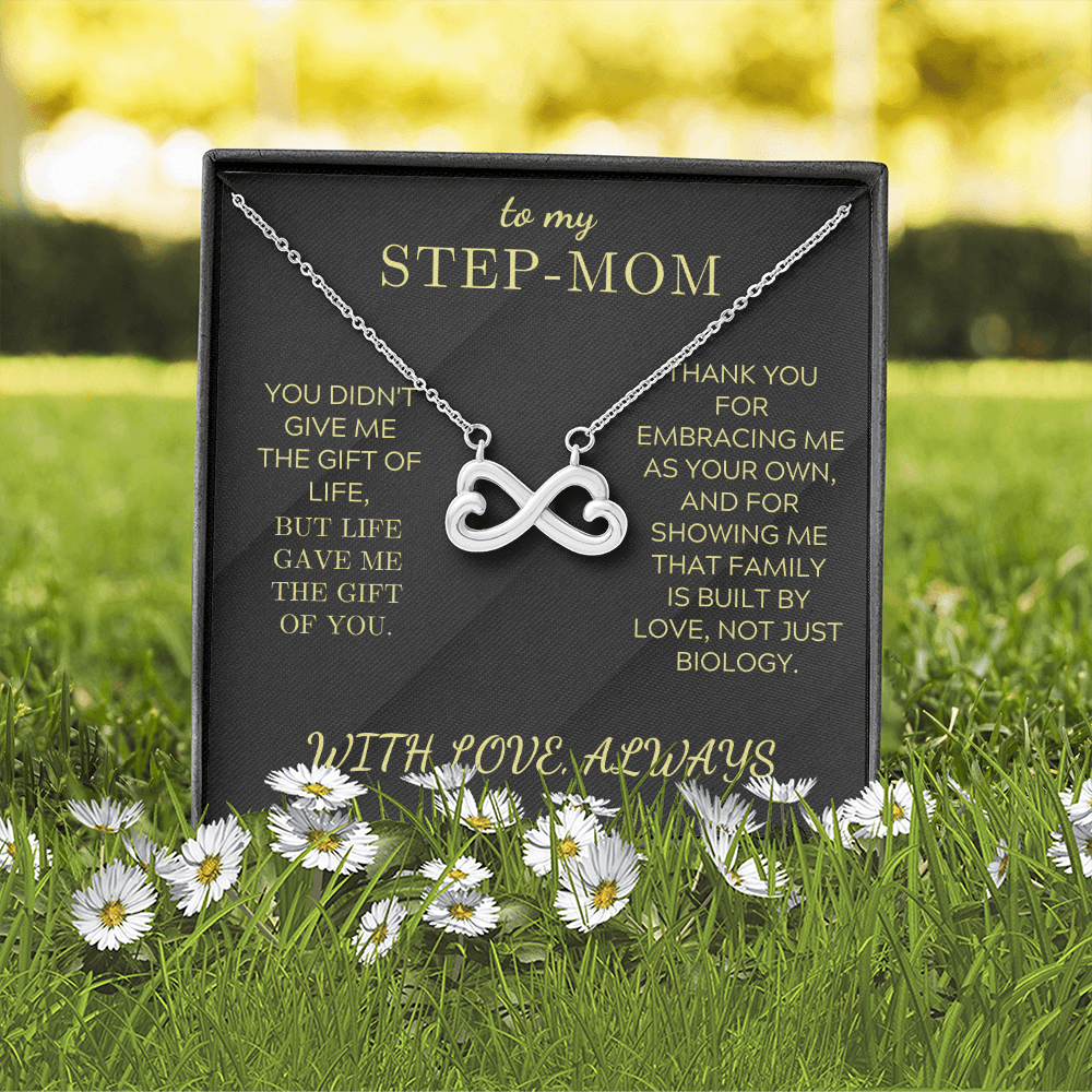 Silver infinity heart pendant necklace in a black gift box outdoors