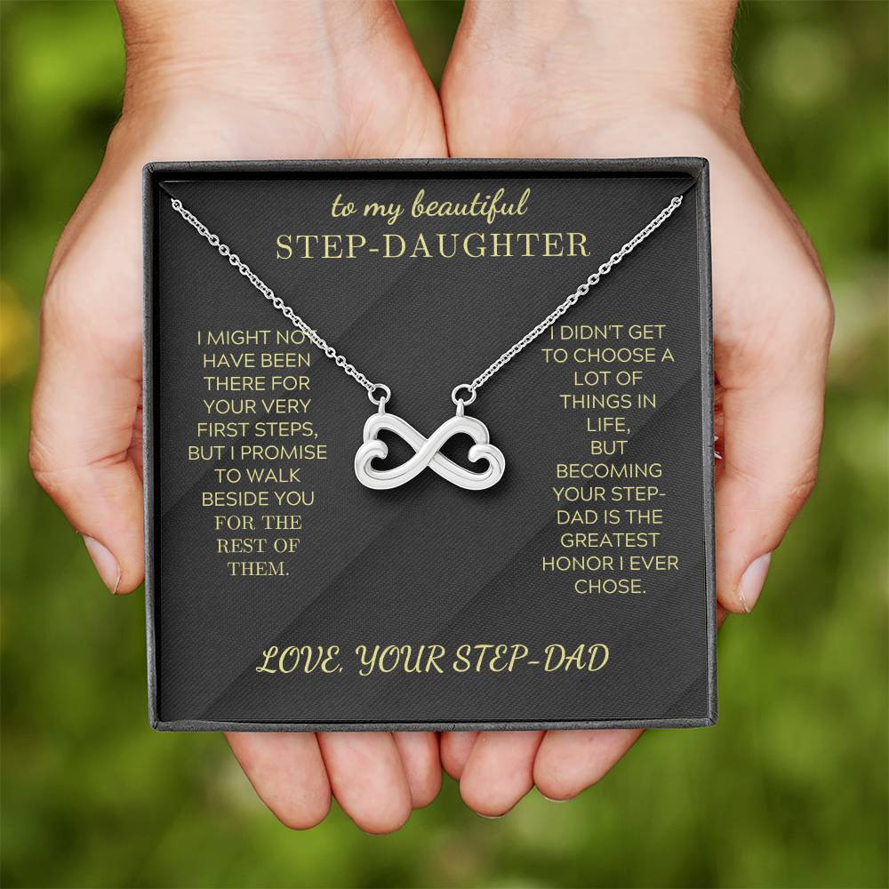 Silver heart-infinity pendant necklace on black gift box held in hands