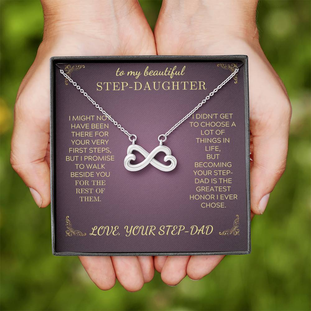 Silver-tone infinity heart pendant necklace in purple gift box held in hands