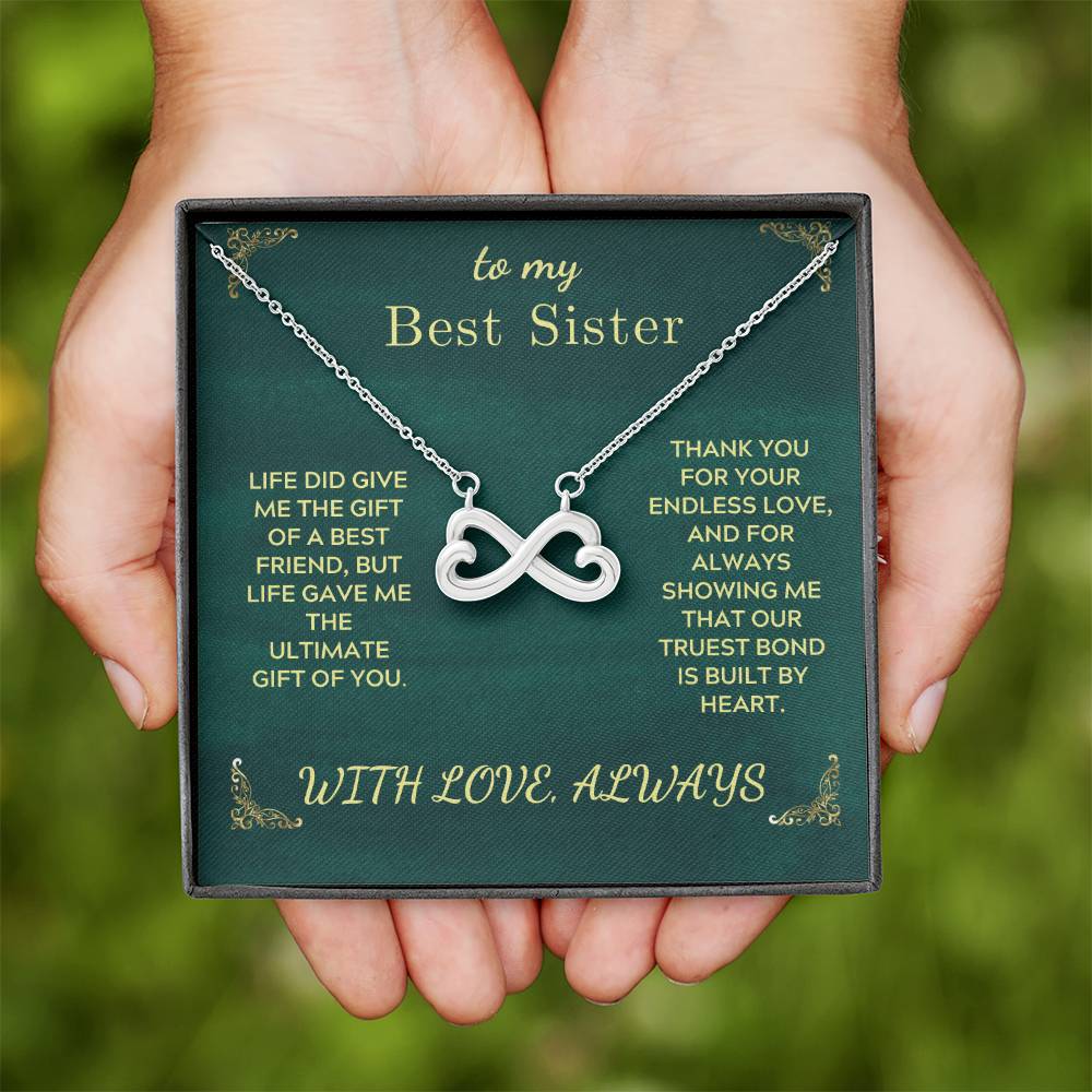 Green gift card box with heart infinity necklace for best sister and message.