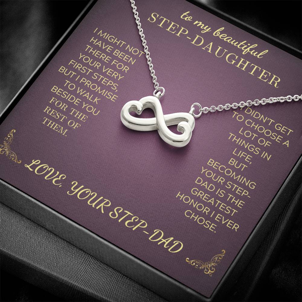 Silver-tone infinity heart pendant necklace on purple gift card, with chain links visible