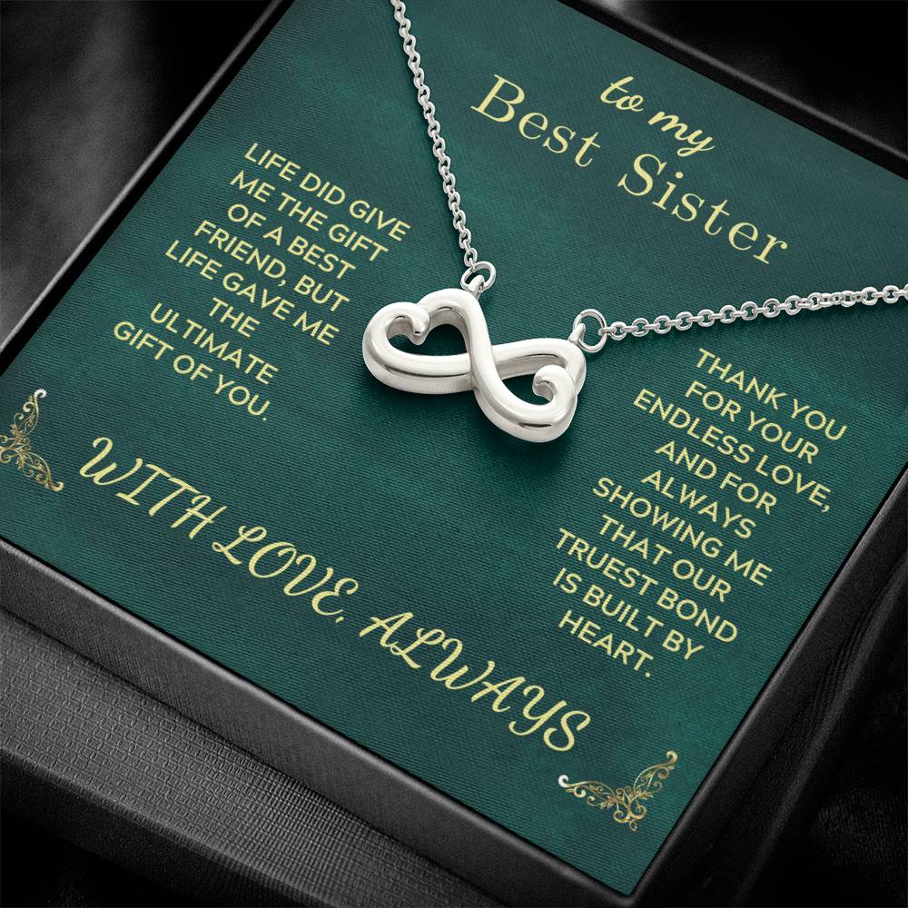 Silver infinity heart pendant necklace on green gift card inside box