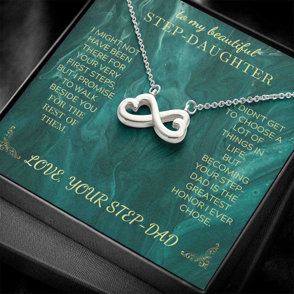 Silver heart infinity pendant necklace on green message card, close-up view