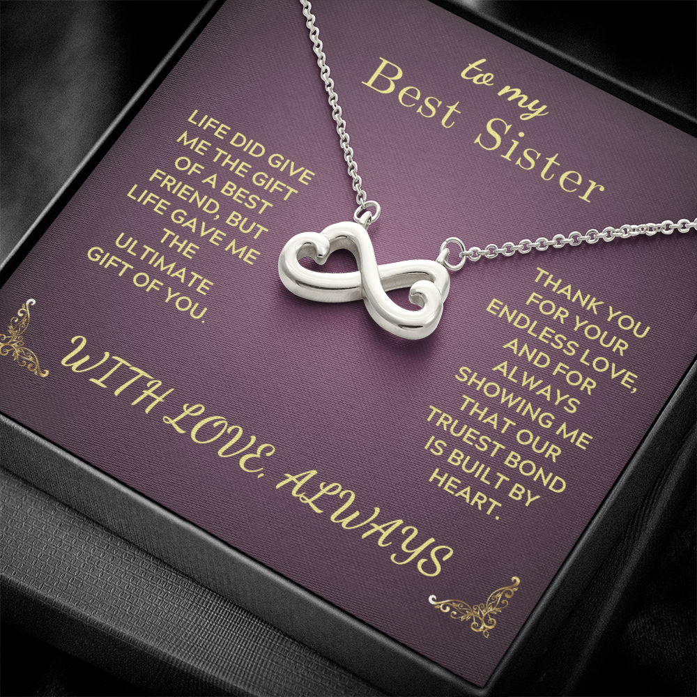 Silver heart-and-infinity pendant necklace on purple gift box insert